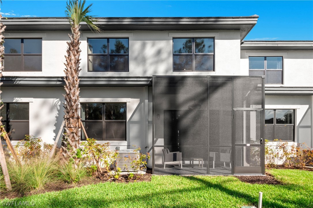 7587 Morgan Way Naples, FL 34119 - Photo 5 of 29 a front view of a house with garden