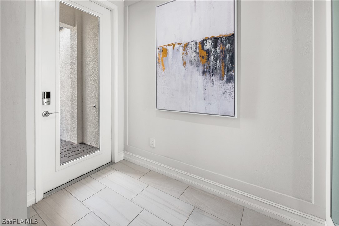 7587 Morgan Way Naples, FL 34119 - Photo 6 of 29 a view of a bathroom with a glass shower door