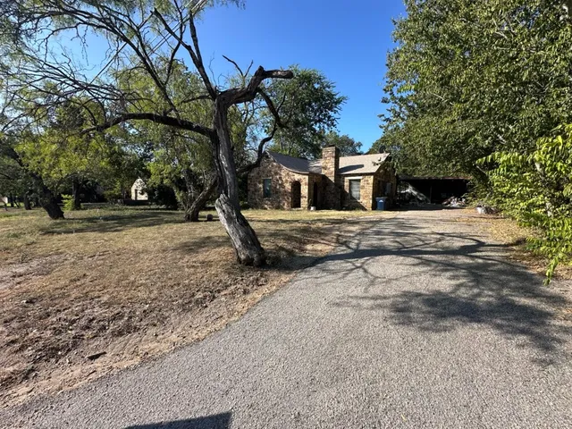 a wooden house with trees in front of it