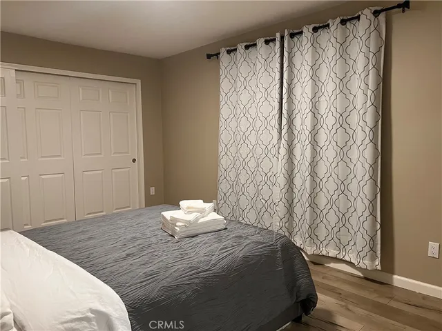 a bedroom with a bed and a rug