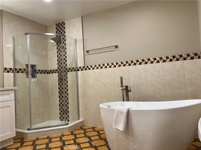 a bathroom with a bathtub and shower