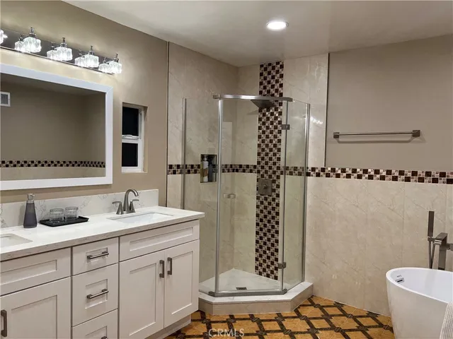 a bathroom with a double vanity sink mirror and toilet