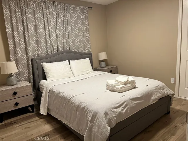 a bedroom with a bed and a night stand