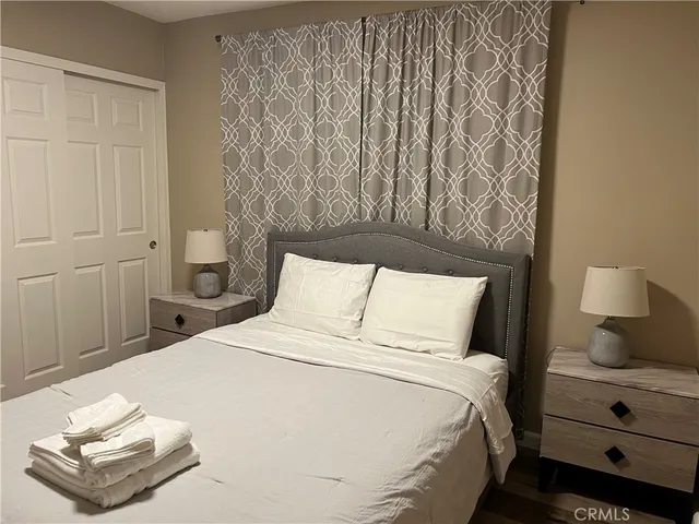 a bedroom with a bed and a night stand