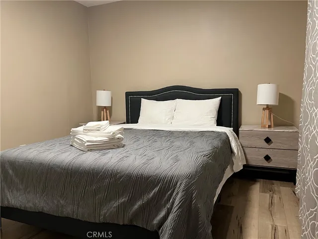 a bedroom with a bed and a lamp
