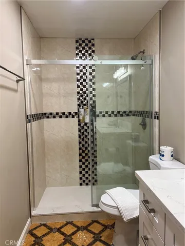 a bathroom with a shower toilet and a sink