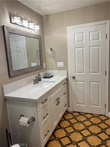 a bathroom with a sink a vanity and a mirror