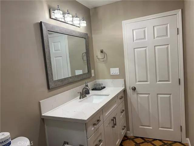 a bathroom with a sink vanity and a mirror