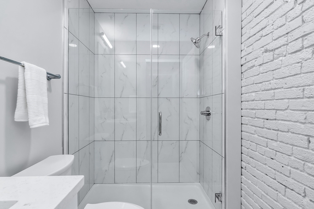 200 Merrimack Street, Unit 202 Haverhill, MA 01830 - Photo 11 of 13 a bathroom with a shower and a toilet