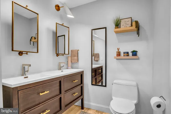 a bedroom with a bed a couch and dresser