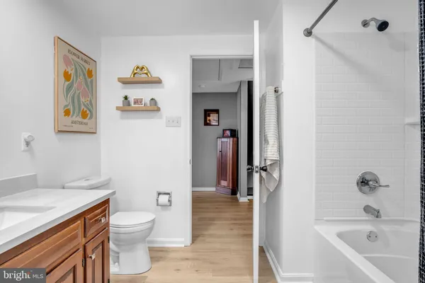 a bedroom with a bed table closet and flat screen tv
