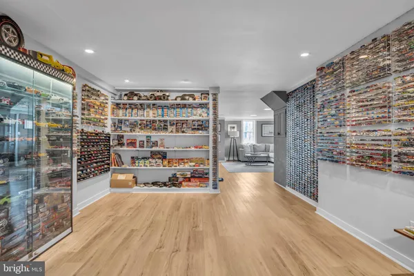 a bathroom with a sink a mirror a toilet and a window