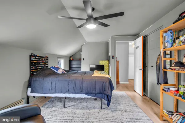 a bedroom with a bed and a painting on the wall