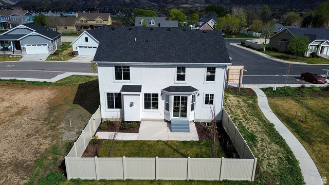 209 North 1140 West Mapleton, UT 84664 - Photo 2 of 21 Back of house featuring a fenced backyard, a residential view, roof with shingles, and stucco siding