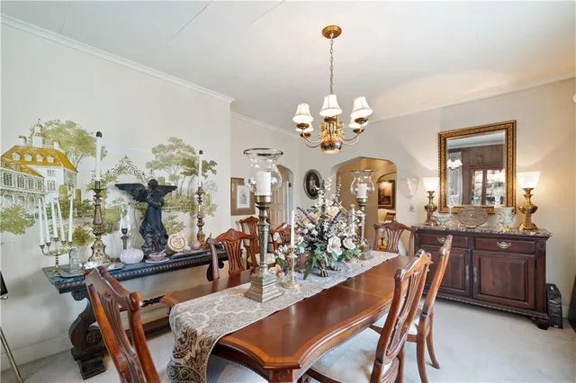 a view of a dining room with furniture and chandelier