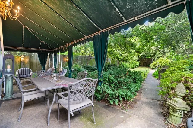 a view of a patio with table and chairs and potted plants