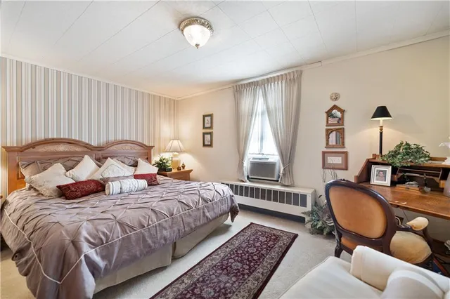 a bedroom with bed chair and window