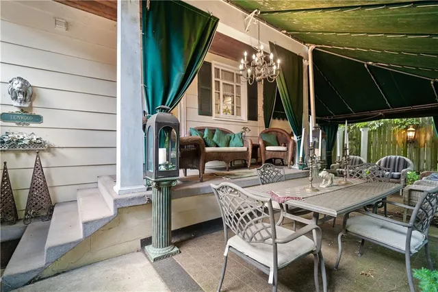 a view of a patio with table and chairs and potted plants