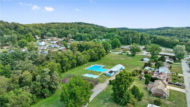 a view of a city with lush green forest