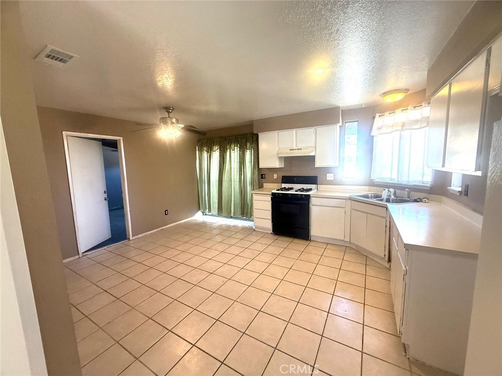495 West 13th Street Perris, CA 92570 - Photo 18 of 32 a large kitchen with a stove a sink dishwasher and a refrigerator