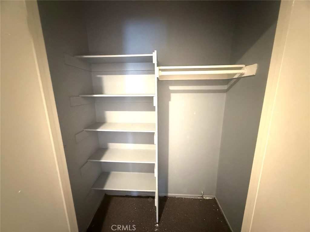 495 West 13th Street Perris, CA 92570 - Photo 21 of 32 a view of walk in closet with empty racks