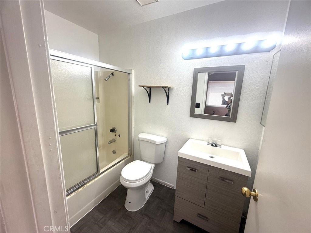 495 West 13th Street Perris, CA 92570 - Photo 26 of 32 a bathroom with a toilet sink and shower