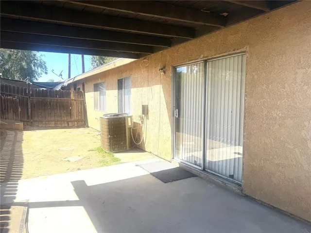 a view of a living room with a balcony and furniture