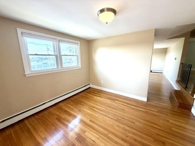 116 Upton Road Waltham, MA 02452 - Photo 12 of 22 a view of empty room with wooden floor and fan