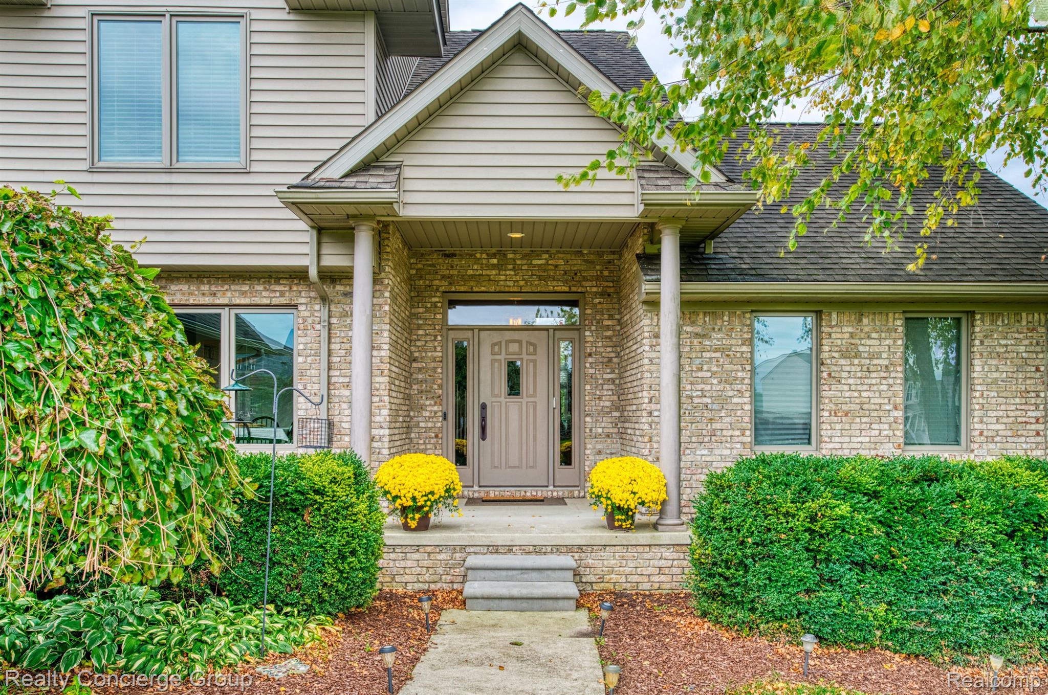1172 Thorn Ridge Drive Howell, MI 48843 - Photo 4 of 71 Manicured landscaping invites you to covered porch