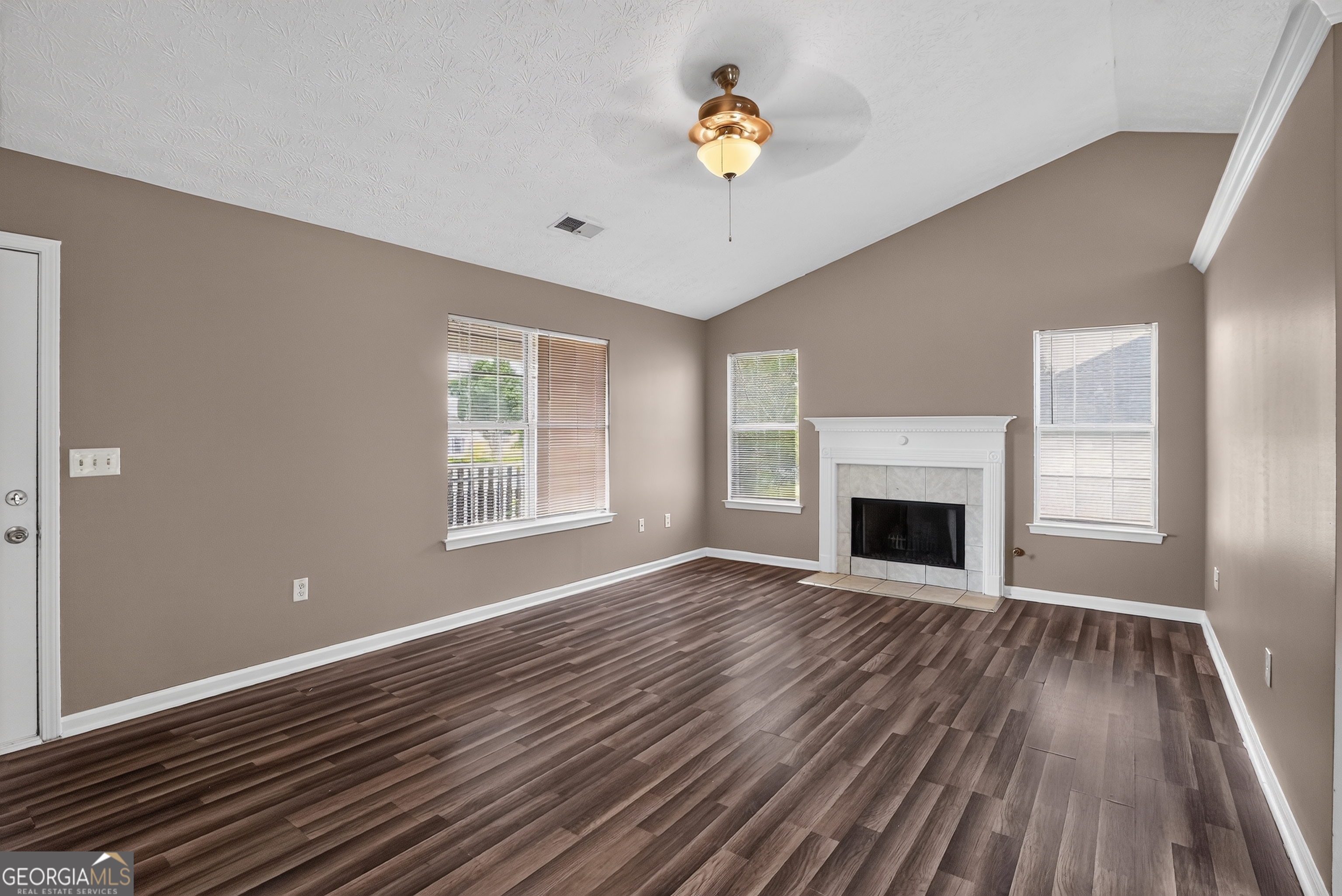 75 Linsley Way Covington, GA 30016 - Photo 24 of 48 a view of empty room with wooden floor and fireplace