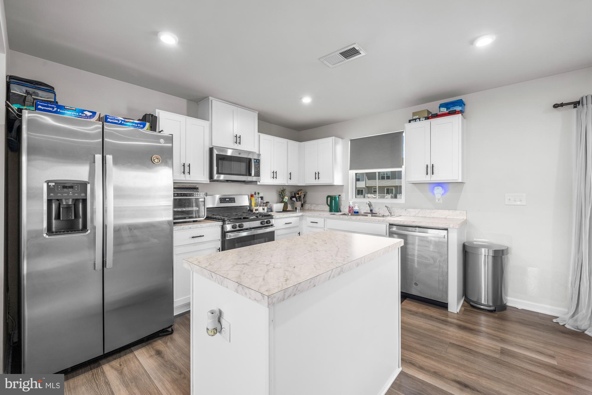 11 Mulberry Lane Clementon, NJ 08021 - Photo 11 of 32 a kitchen with kitchen island a refrigerator sink and microwave