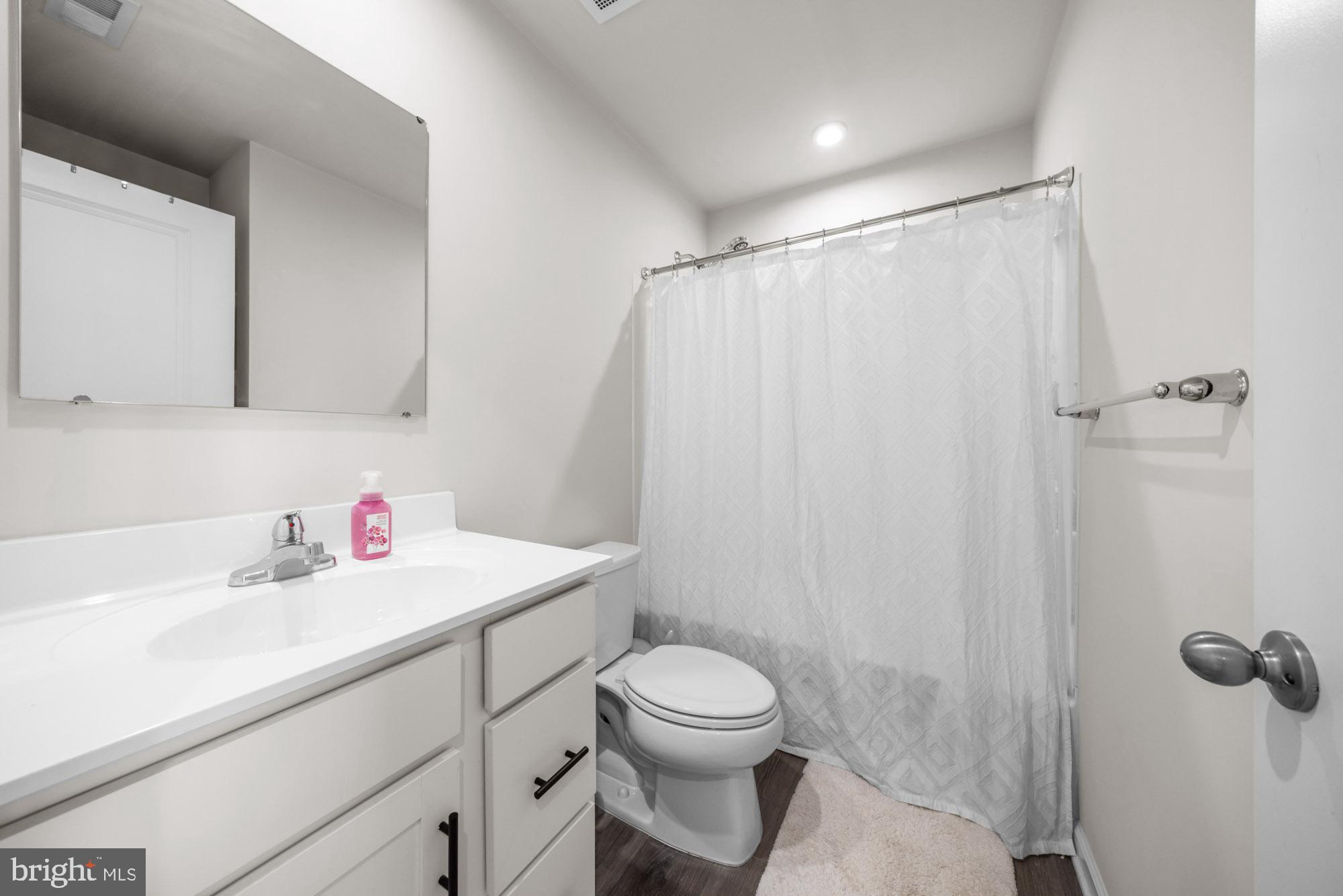 11 Mulberry Lane Clementon, NJ 08021 - Photo 26 of 32 a bathroom with a sink a toilet and shower curtain