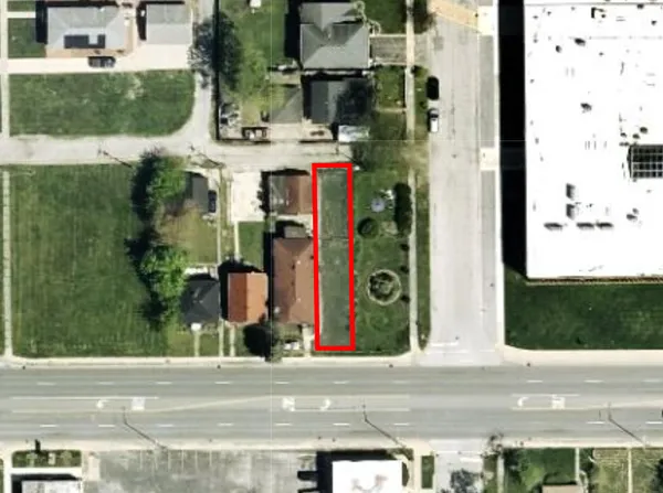 front view of house with a yard and car parked