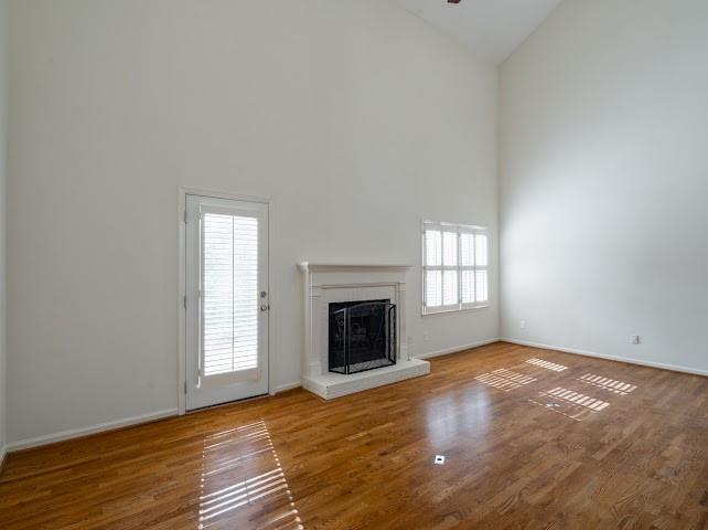 1307 Whitlock Ridge Drive Marietta, GA 30064 - Photo 4 of 29 an empty room with wooden floor fireplace and windows