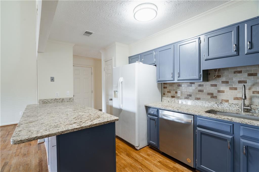1307 Whitlock Ridge Drive Marietta, GA 30064 - Photo 10 of 29 a kitchen with stainless steel appliances granite countertop a sink stove and refrigerator