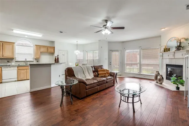 a living room with fireplace furniture and a wooden floor