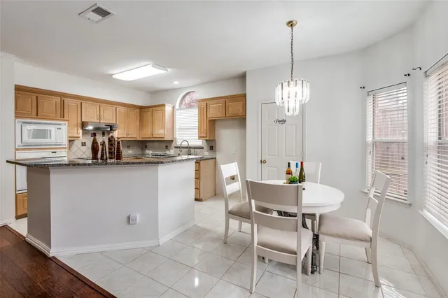 a kitchen with counter top space cabinets and appliances