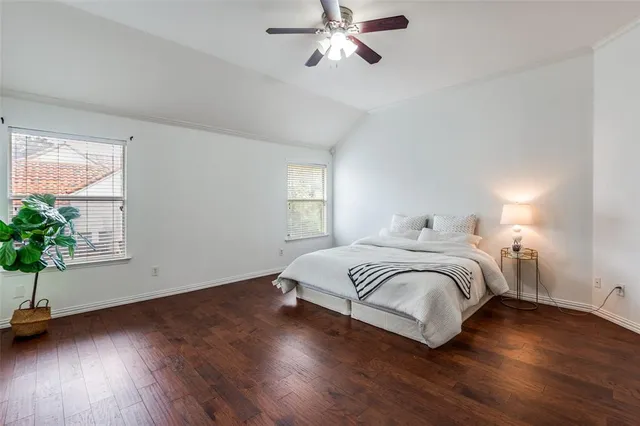 a bedroom with a bed and a potted plant