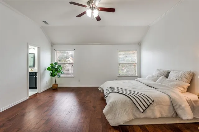 a bedroom with a bed and a potted plant