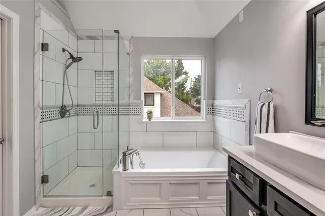a bathroom with a bathtub and a shower