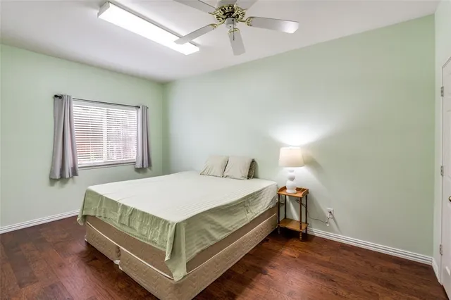 a bed sitting in a bedroom next to a window and a chandelier