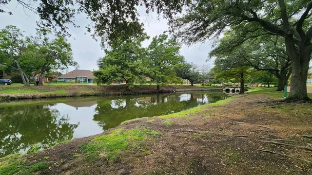 a view of a lake with houses in background