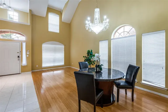 a view of a dining room with furniture and chandelier