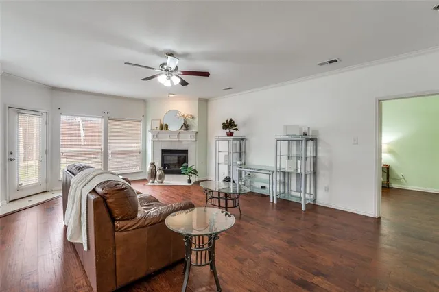 a living room with furniture a fireplace and wooden floor