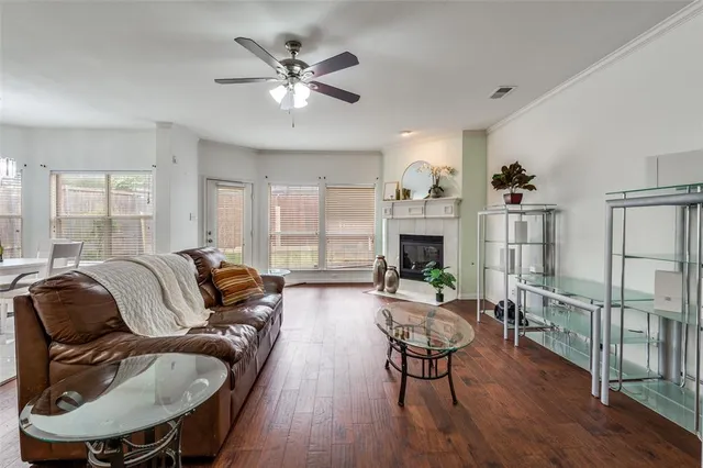 a living room with fireplace furniture and a wooden floor
