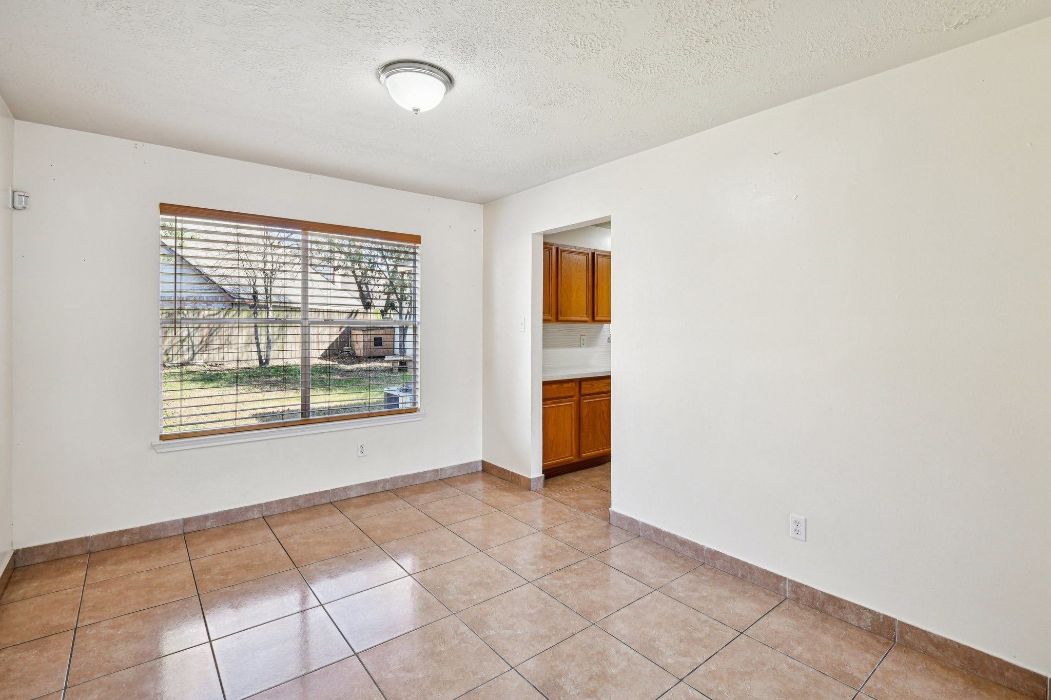12270 Cobbs Creek Road Houston, TX 77067 - Photo 14 of 42 a view of an empty room with a window