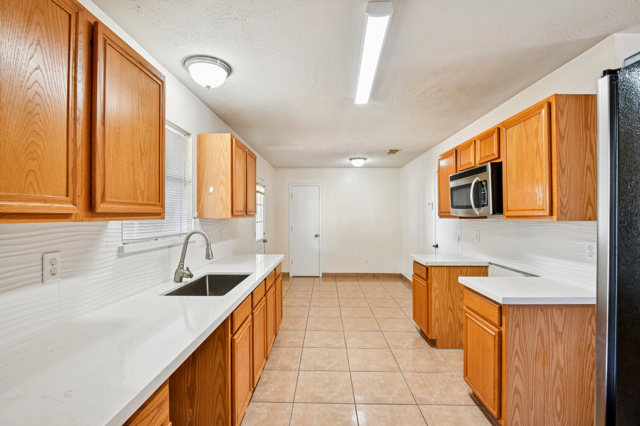 12270 Cobbs Creek Road Houston, TX 77067 - Photo 3 of 42 a kitchen with stainless steel appliances a sink stove and cabinets