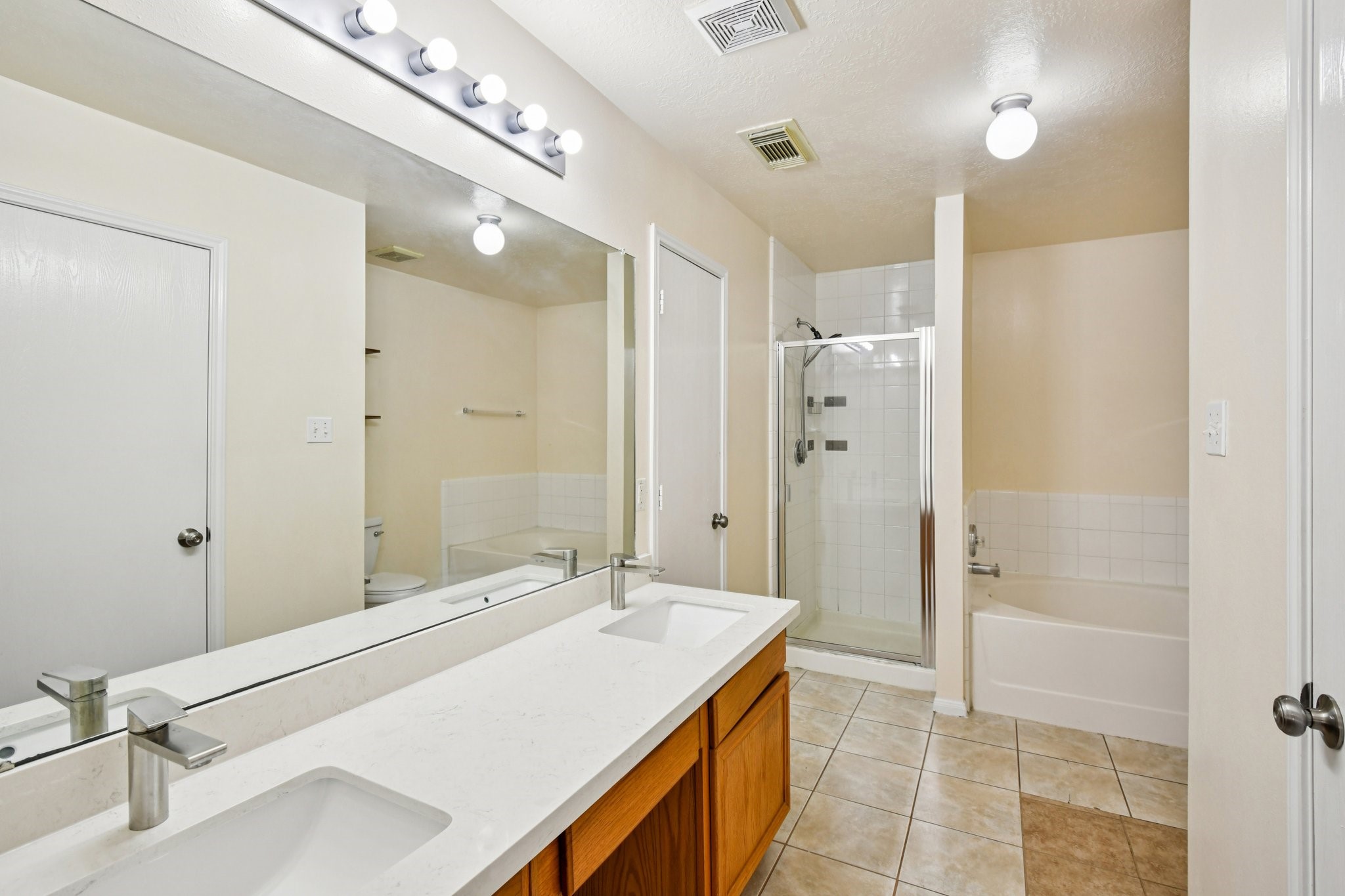 12270 Cobbs Creek Road Houston, TX 77067 - Photo 35 of 42 a spacious bathroom with a shower sink and mirror