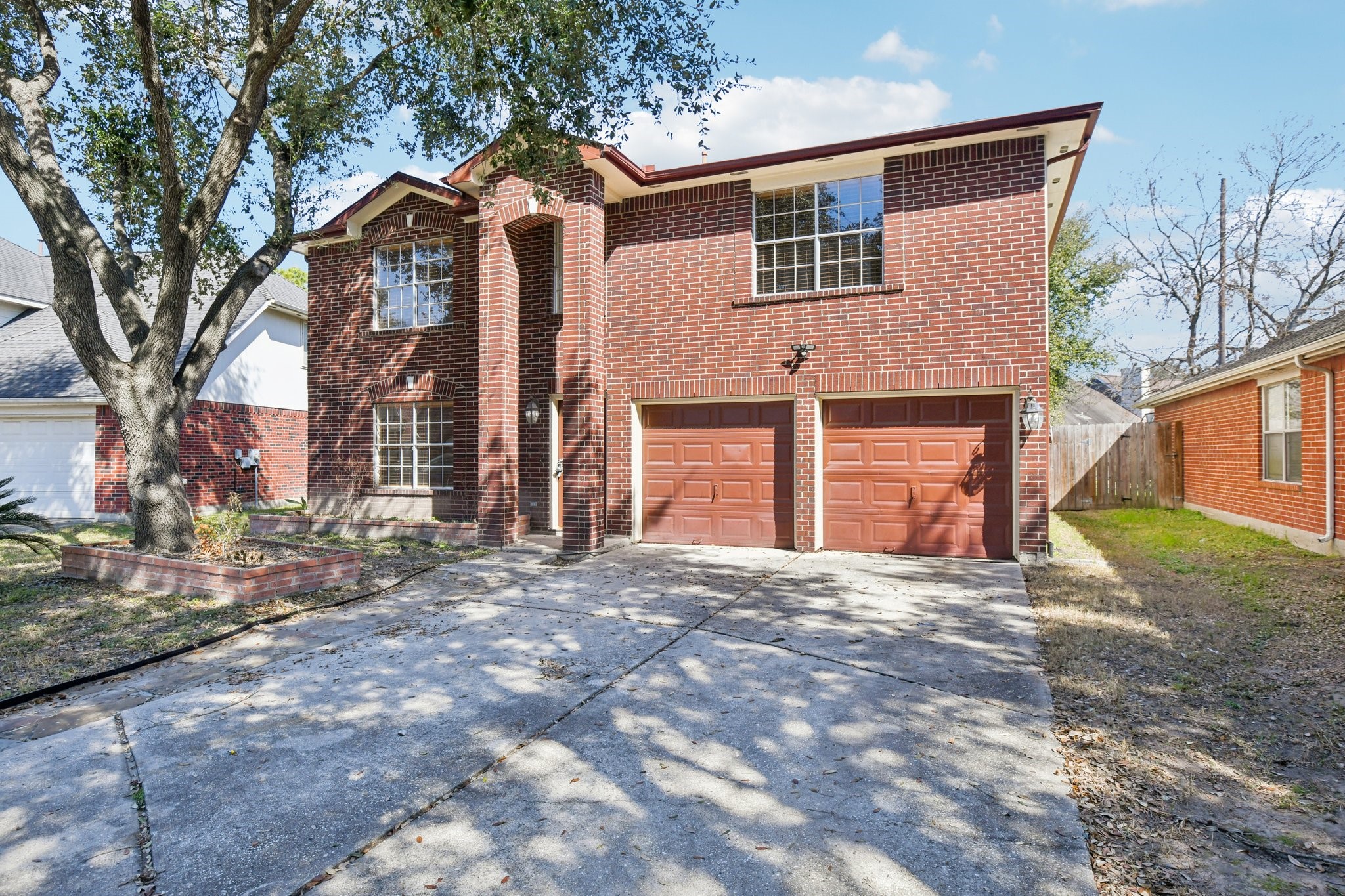 12270 Cobbs Creek Road Houston, TX 77067 - Photo 6 of 42 a front view of a house with a yard and garage