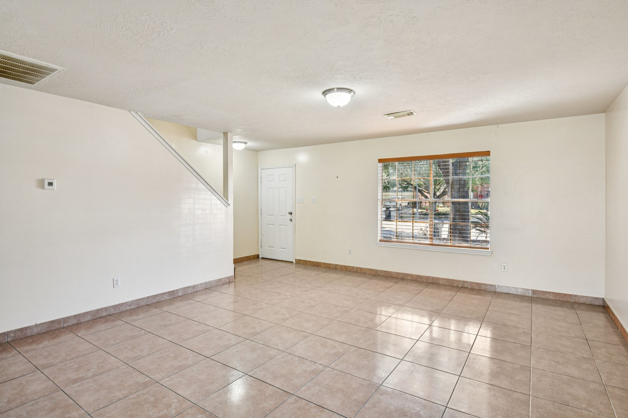12270 Cobbs Creek Road Houston, TX 77067 - Photo 8 of 42 a view of an empty room with a window